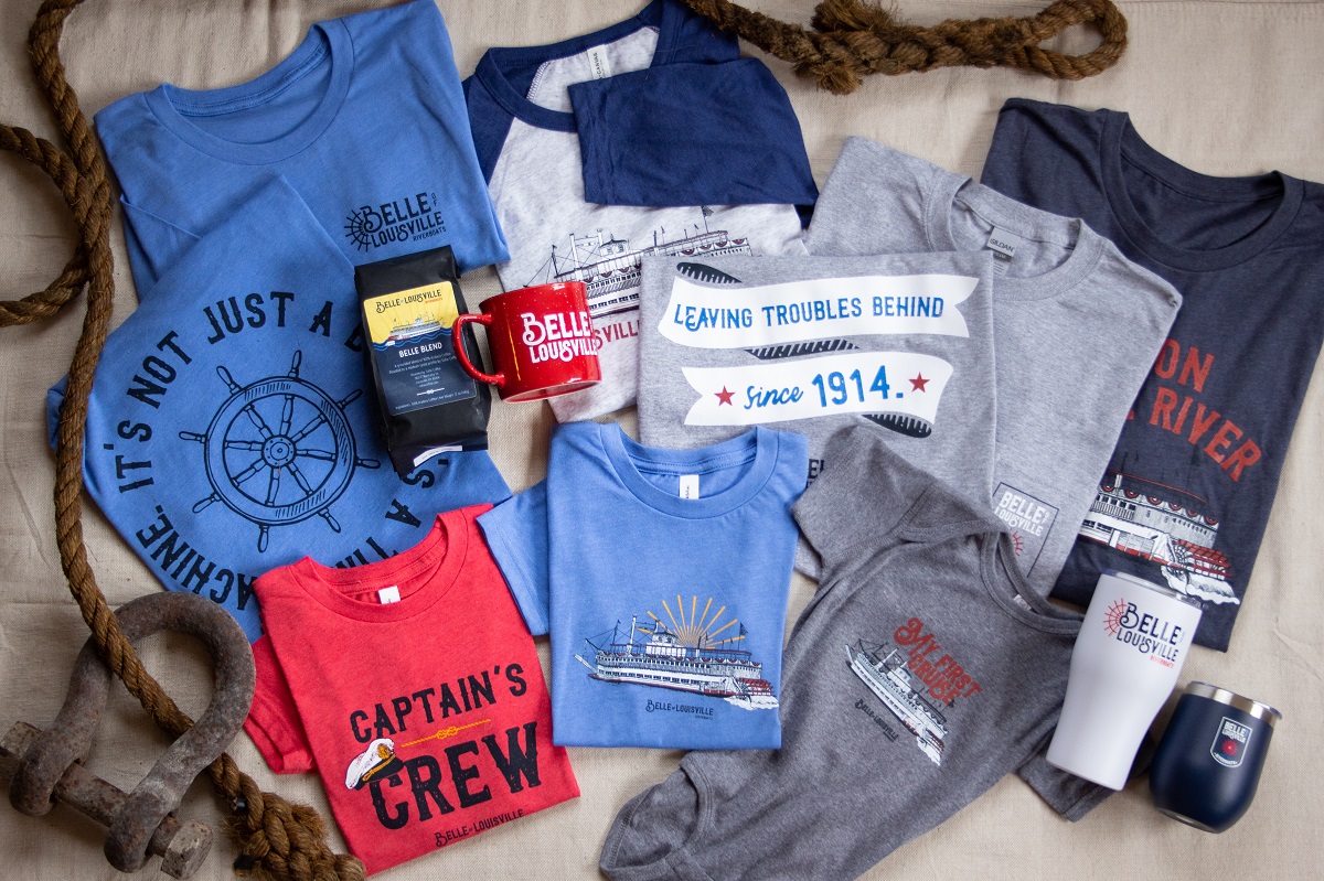 An assortment of Gift Shop items-including apparel, drinkware and coffee-arranged in a flat lay.