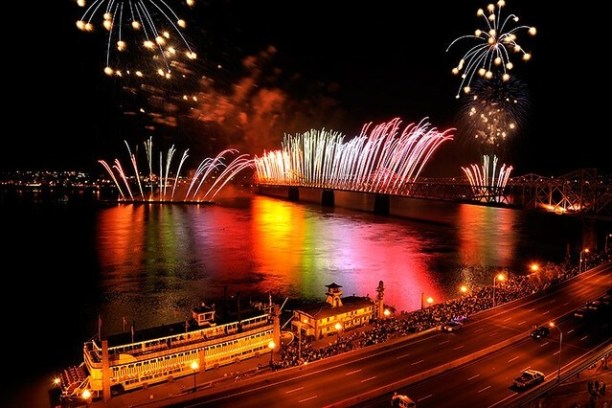 fireworks in the night sky over a body of water